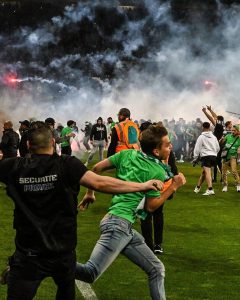 PHOTOS: Saint-Étienne fans stormed the pitch and threw flares at their own players after the club were relegated to Ligue 2 in the relegation playoffs