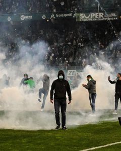 PHOTOS: Saint-Étienne fans stormed the pitch and threw flares at their own players after the club were relegated to Ligue 2 in the relegation playoffs